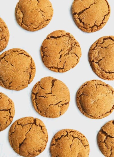 Chewy ginger molasses cookies on a white surface.