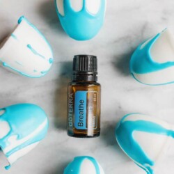 White bath soaps with blue drizzle surrounding a bottle of doTerra Breathe.
