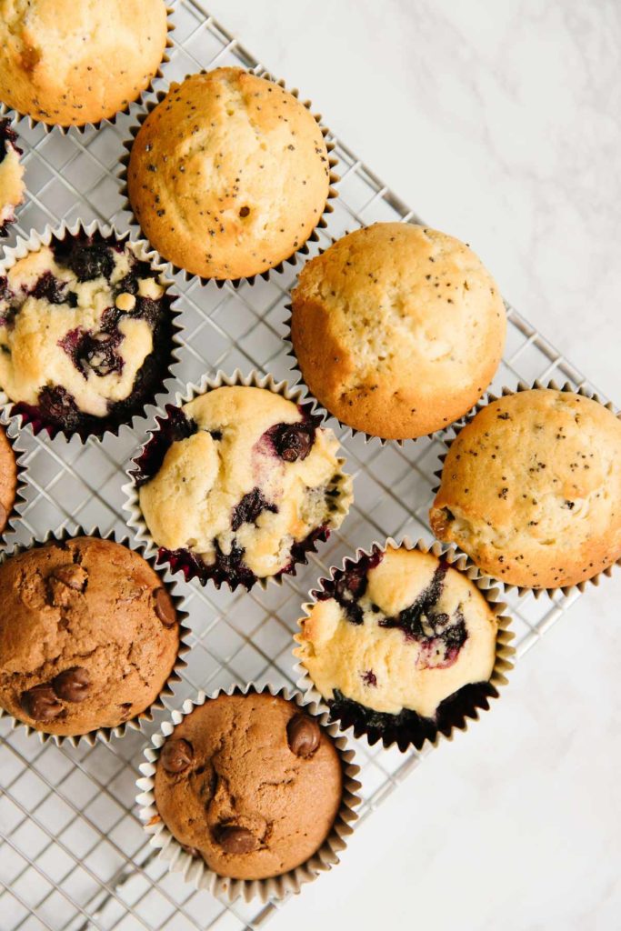 Three different types of breakfast muffins on a cooling rack.