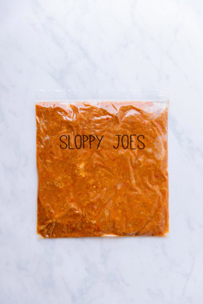 A gallon size Ziploc bag with an orange mixture with the words "Sloppy Joes" written on the front.