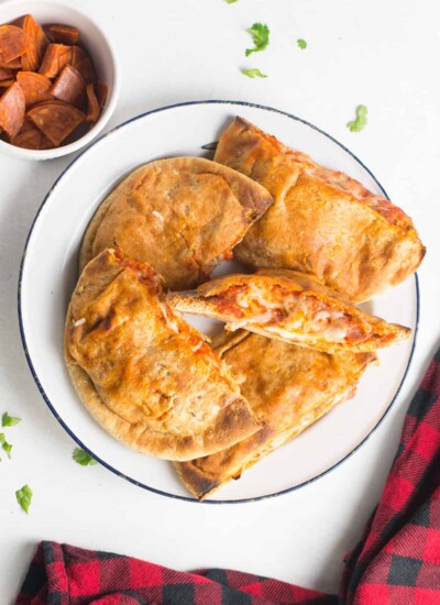 Homemade pizza pockets on a plate.