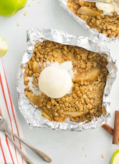 Apple crisp foil packet topped with a scoop of ice cream.