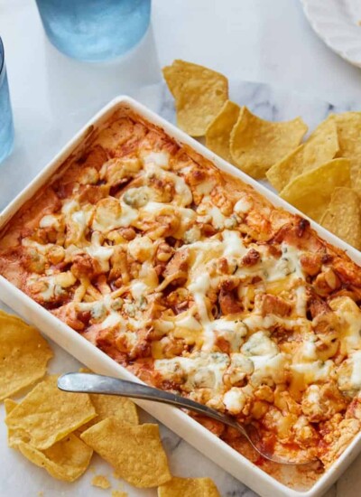 Spoon in a baking dish of spicy buffalo chicken hot dip.