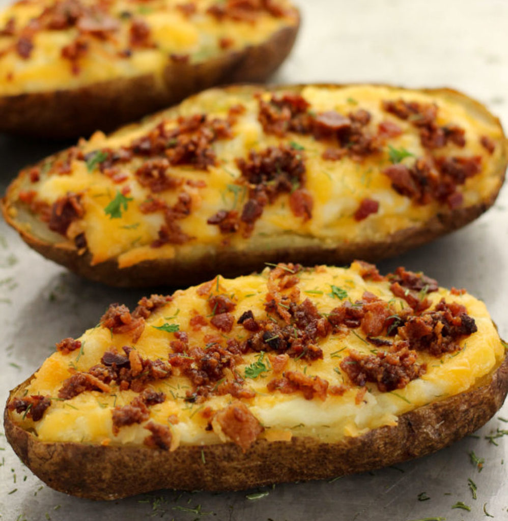 Twice baked potatoes topped with diced bacon, cheese and a little bit of dill. 