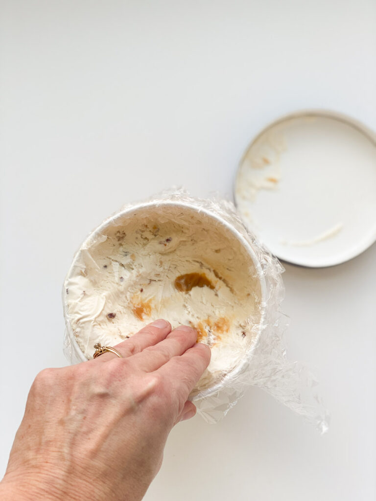 Best way to prevent freezer burn on ice cream is to add plastic wrap on top of any unused portions and add lid back on. 