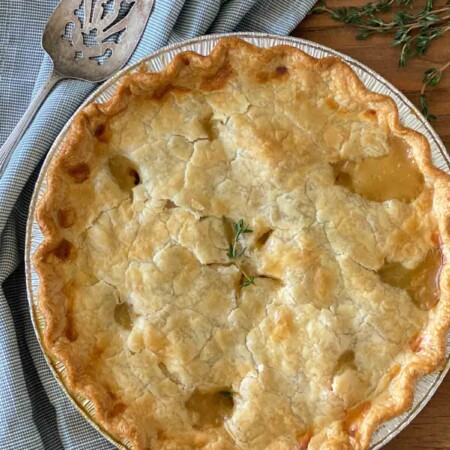 Serving utensil next to a chicken pot pie.