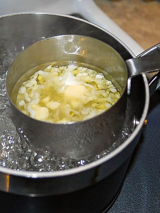 Make your own chapstick. Melting down ingredients for making homemade chapstick in a pot. 