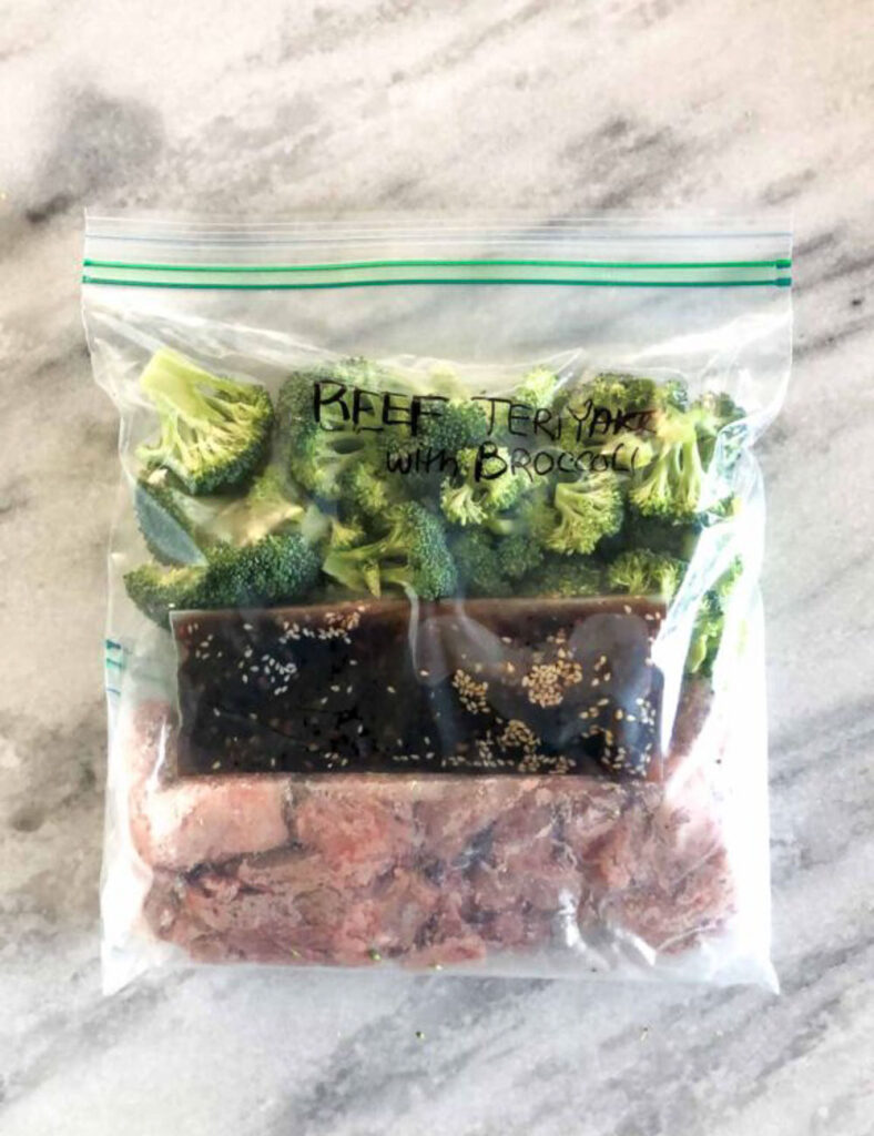 Freezer bag prepped with ingredients for beef and broccoli teriyaki.