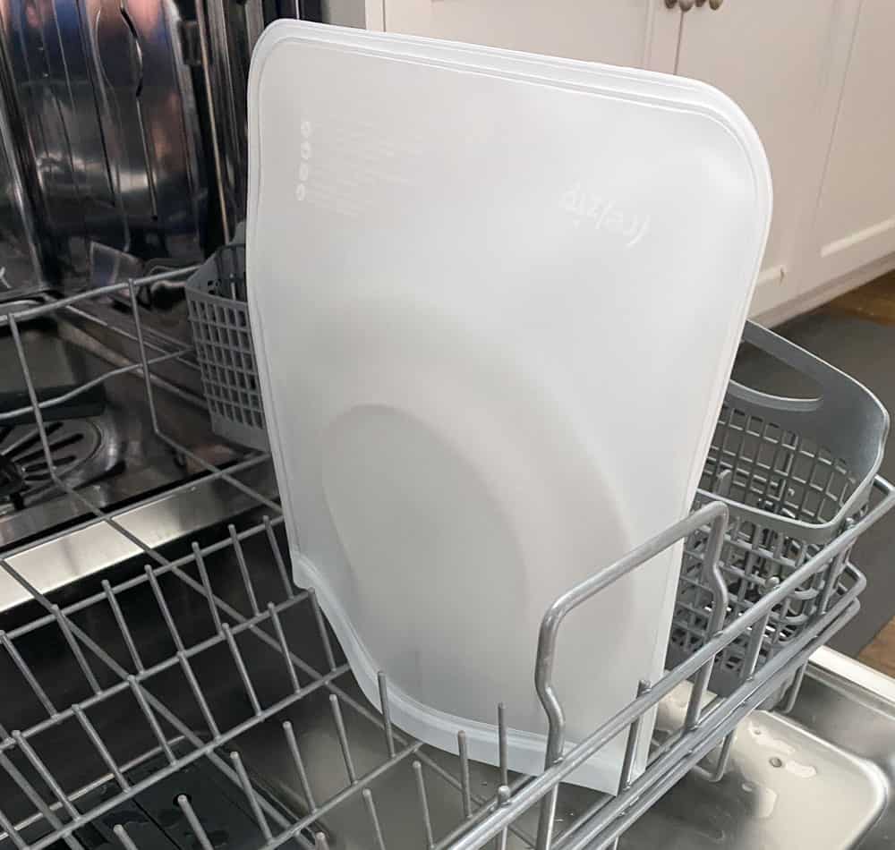 How to wash reusable gallon size freezer bags in dishwasher by adding the bag over a dinner plate. 