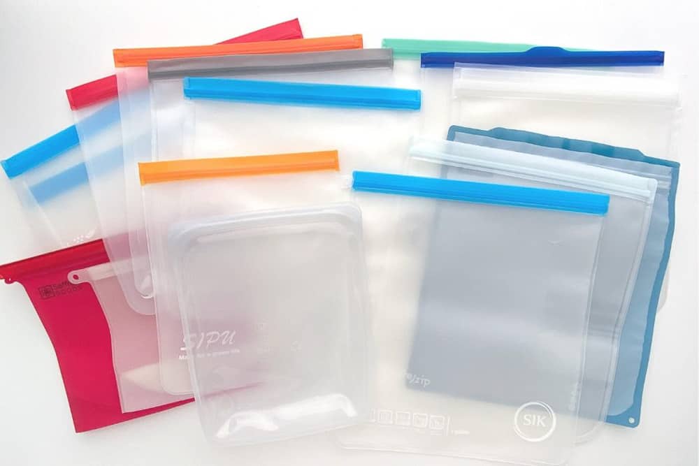 Variety of different reusable freezer bags that I'm testing, layered on a white background