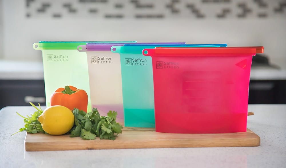Four Saffron Goods reusable silicone freezer bags in different colors