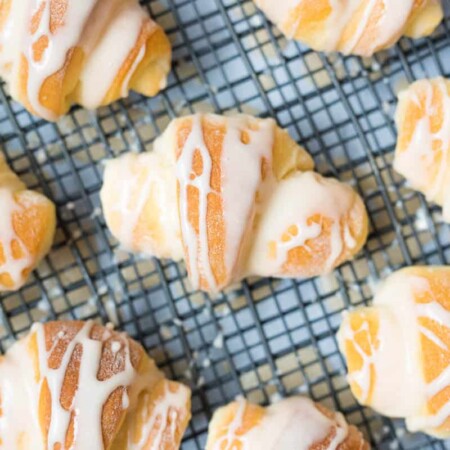 Glazed butterhorns on a wire rack.