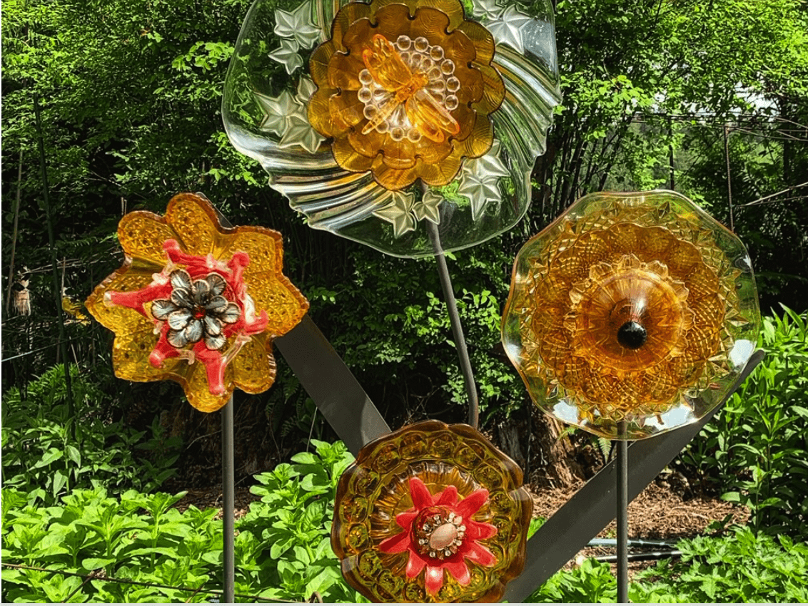 17 Frugal and Free Mother's Day Gift Ideas - 4 glass plate flower crafts out in the green outdoors.