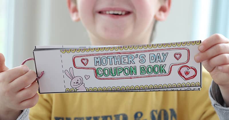 17 Frugal and Free Mother's Day Gift Ideas - A young boy holding a Mother's Day coupon book