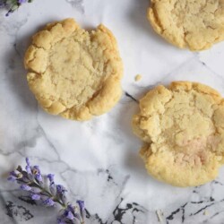 Sugar lavender cookies on a marbled countertop.