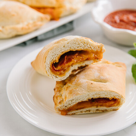 Halved homemade Hot Pocket on a white plate.