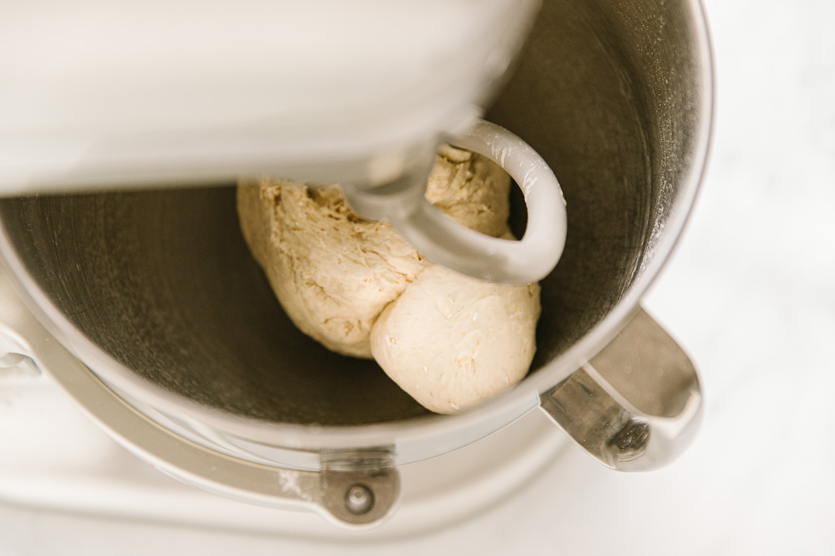 A mixer with dough in it.