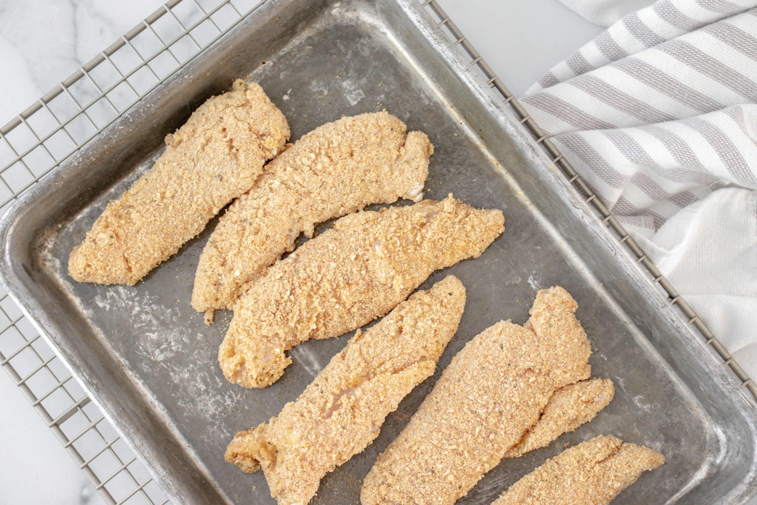 A metal pan of chicken strips.