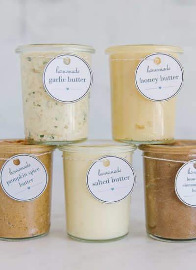 Five clear containers of flavored butter.