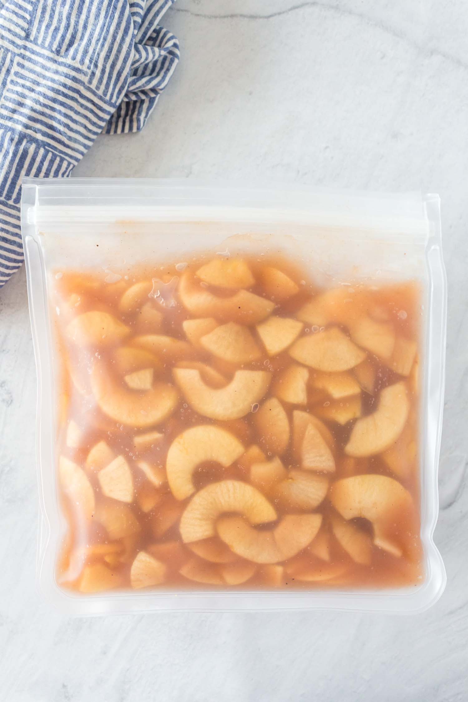 A resealable freezer bag full of apple pie filling.