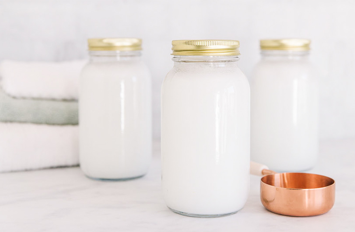 Glass jars of homemade fabric softener.