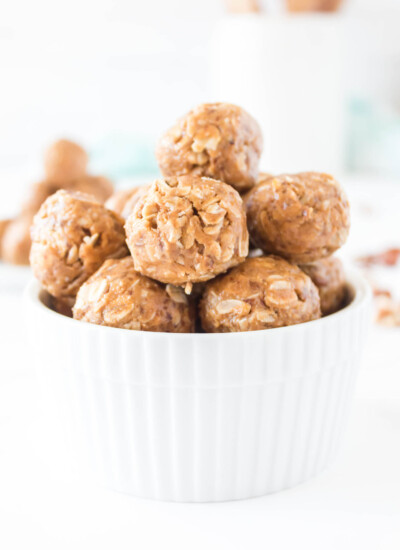 No-bake protein balls piled in a white bowl.
