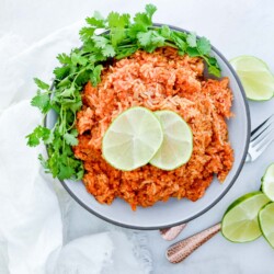 Limes on a pile of Spanish rice.