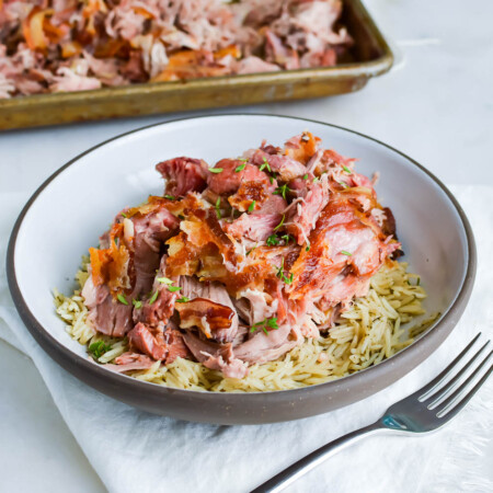 Bacon-wrapped Kalua pork over rice in a bowl.