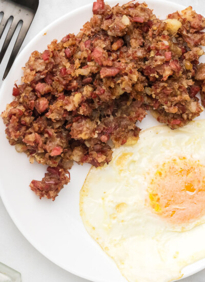 Corned beef hash on a plate with an egg.
