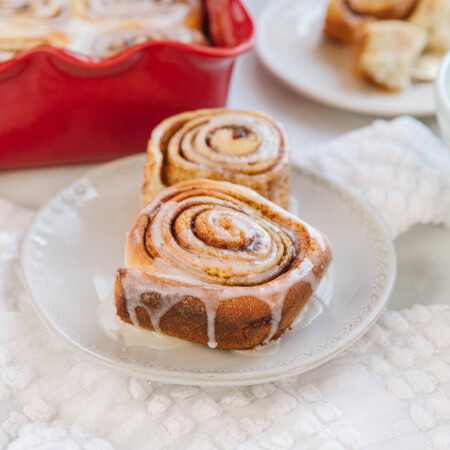 Two potato cinnamon rolls on a small plate.