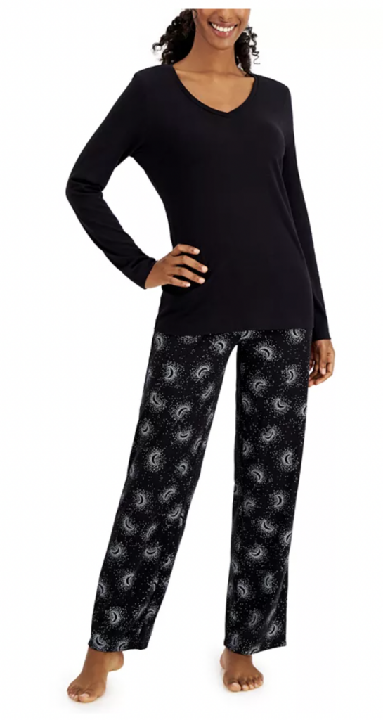 Person wearing black pajamas with moons on the pajama pants.