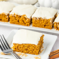 pumpkin bar with cream cheese frosting on a plate with a fork.