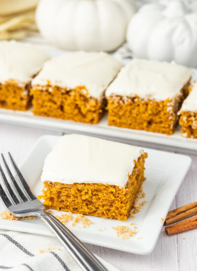 pumpkin bar with cream cheese frosting on a plate with a fork.