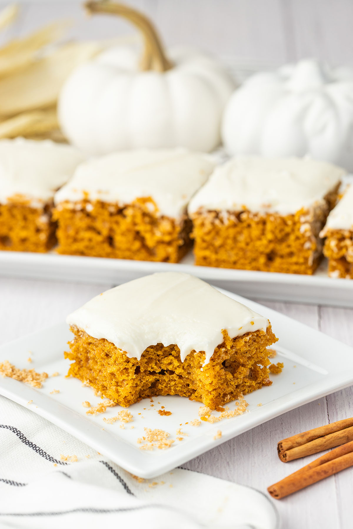 pumpkin bar with cream cheese frosting with a bite.