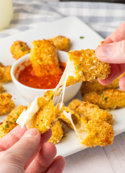hand pulling apart a mozzarella stick.