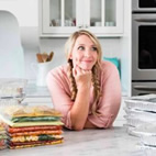 Karrie standing in kitchen with freezer meals.