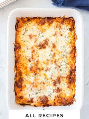 Lasagna in a white baking pan.