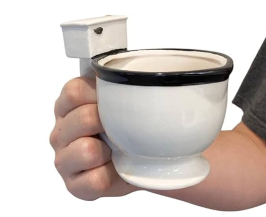 Toilet coffee mug held in someones hand