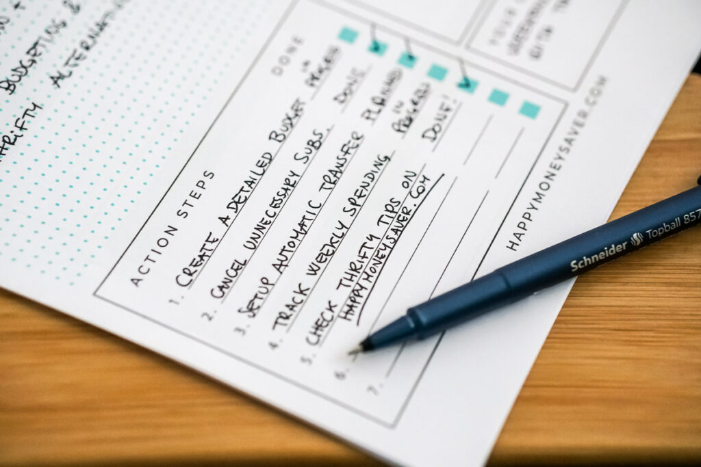 pen sitting on a goal planner paper filled out.